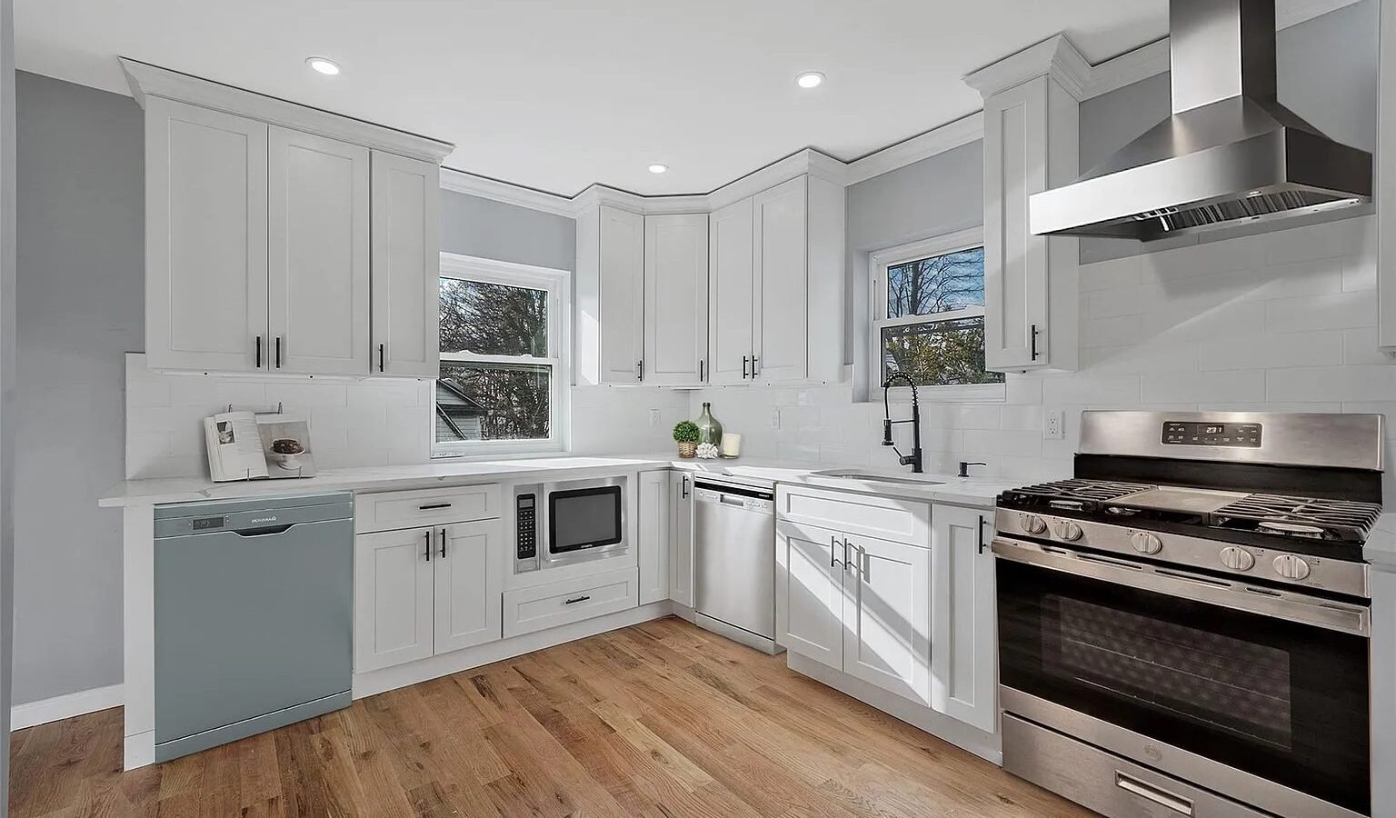 White kitchen with stainless range and hood