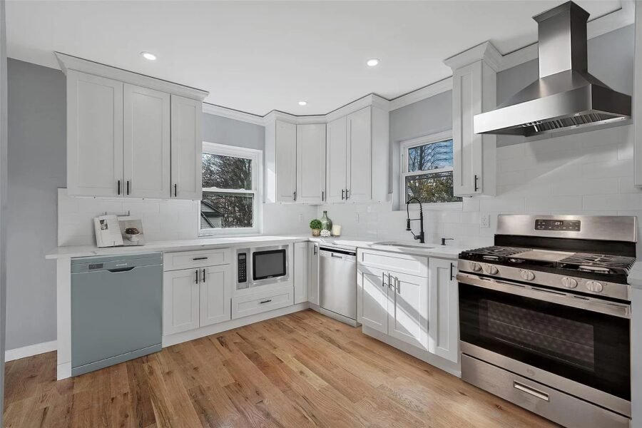 White kitchen with stainless range and hood