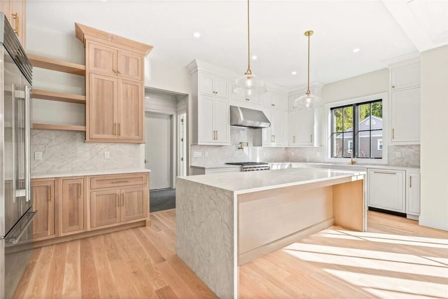 Kitchen with natural wood cabinets and stone waterfall island
