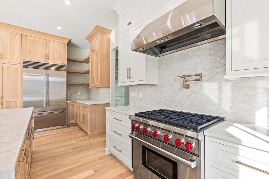 Kitchen with professional gas range, hood and wood cabinets