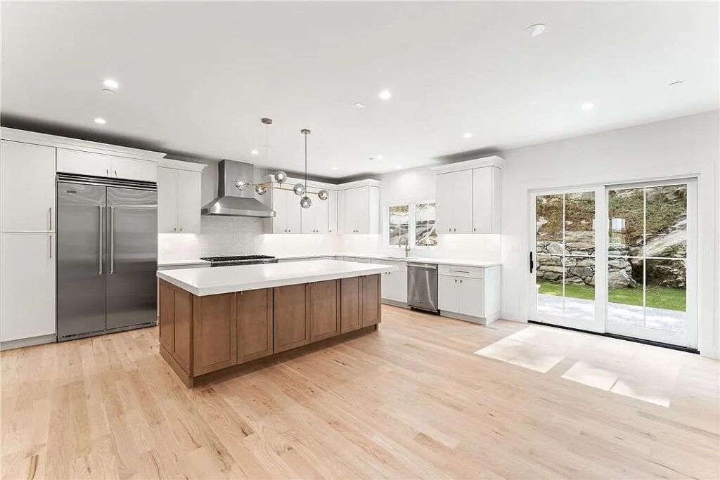 Kitchen with stainless refrigerator and wood island