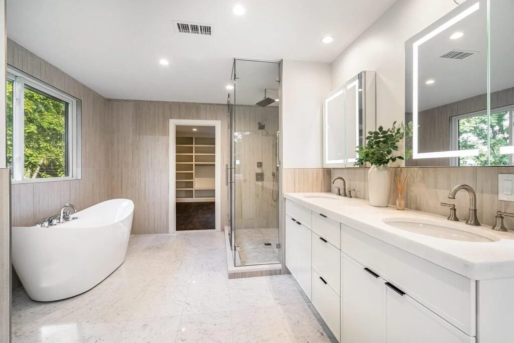 Primary bath with soaking tub, double vanity and glass shower