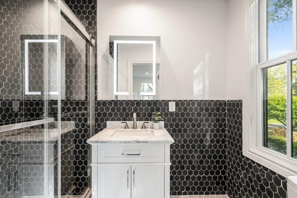 Bathroom with black hex tile wall and white vanity