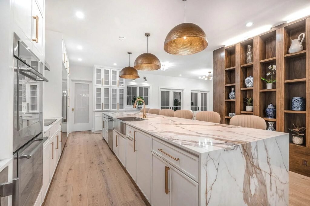 Kitchen with marble backsplash and marble topped island