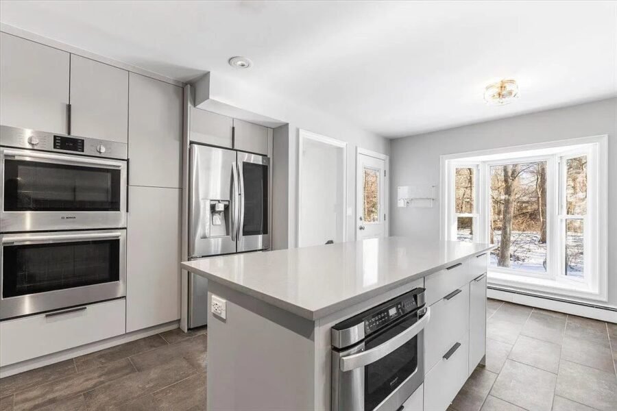 Kitchen with double ovens and white island