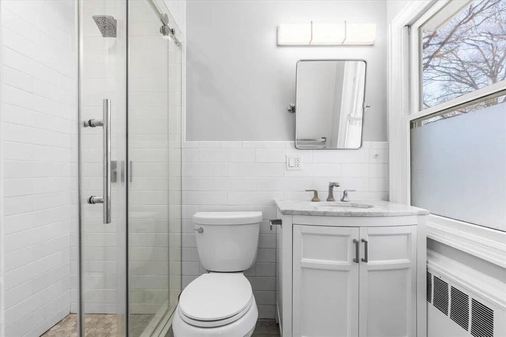 Bathroom with glass shower and white vanity