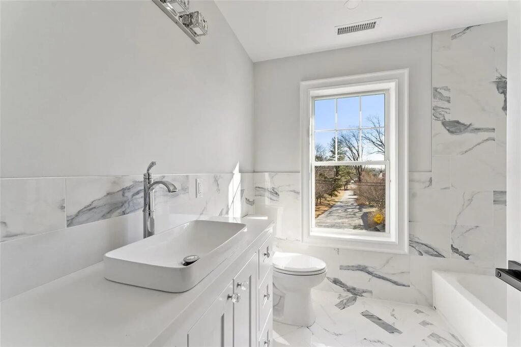 Bathroom with vessel sink and marble tile