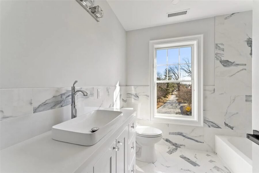 Bathroom with vessel sink and marble tile